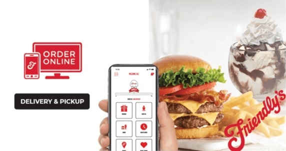 Mobile phone being held showing Friendly's mobile app with double cheese burger and vanilla sunday with chocolate syrup in the background